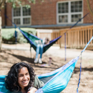 Student smiling from a hammock