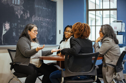 Students talk with an advisor.