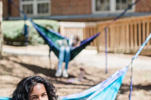 Student smiling from a hammock