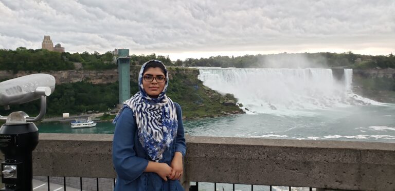 Furyal Ahmed in front of a waterfall