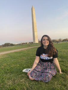 Charlotte Capers sits on the lawn in front of the Washington Monument