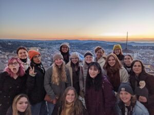 Group shot of students in Tuscany with sunset in background