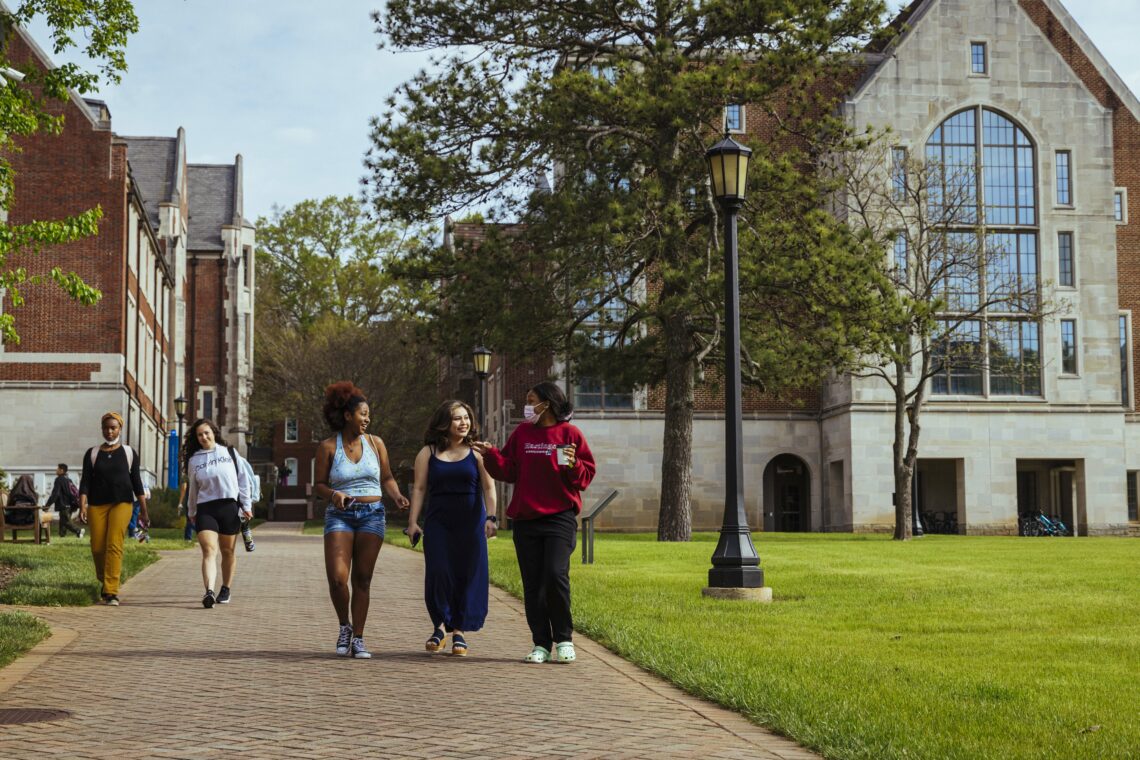 Three ASC students walk down the path next to the science quad.